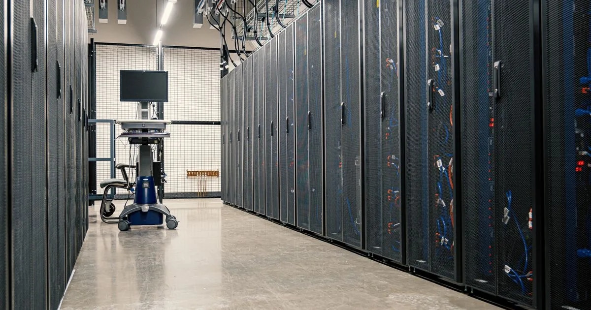 A modern data center corridor with rows of server racks, representing the data pipeline behind a dashboard