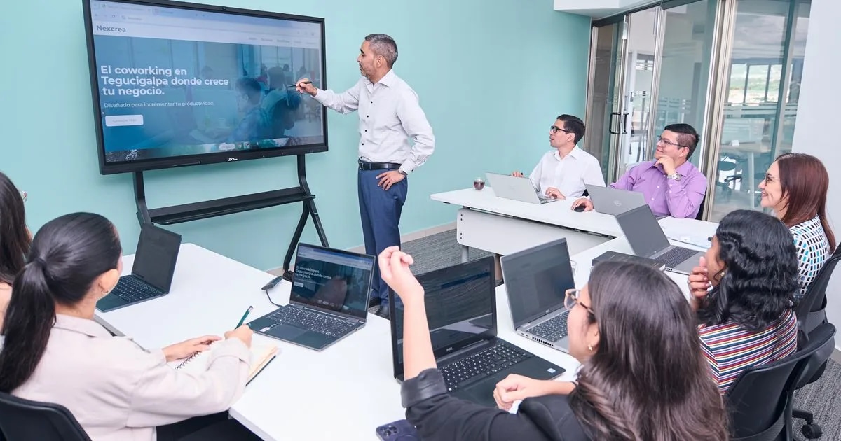 A professional team presenting business metrics to clients in a modern office